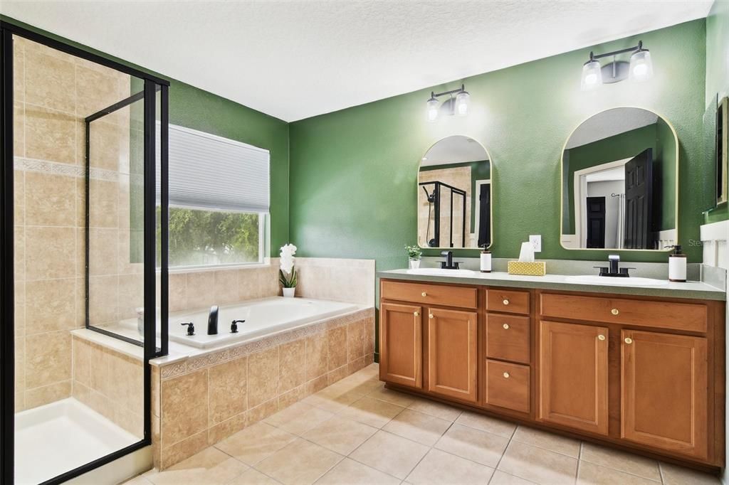 Freshly painted Primary Bathroom with Double-sink Vanity, Garden Tub and Seperate Shower, and Private Toilet Room.