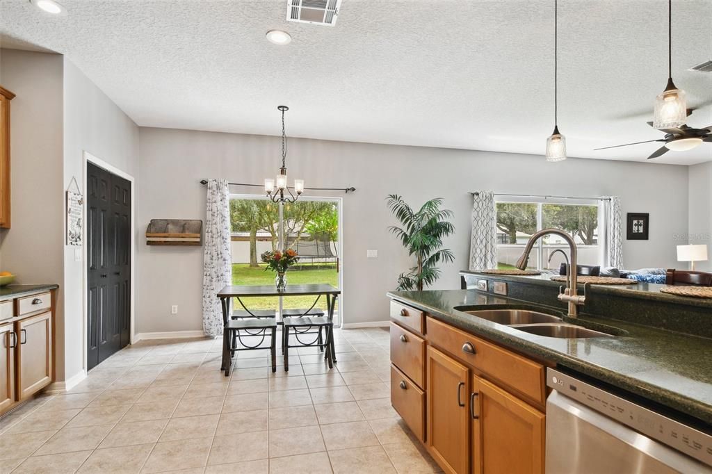 Bright kitchen area with plenty of room for a portable island. View of Breakfast Nook and Back Yard.