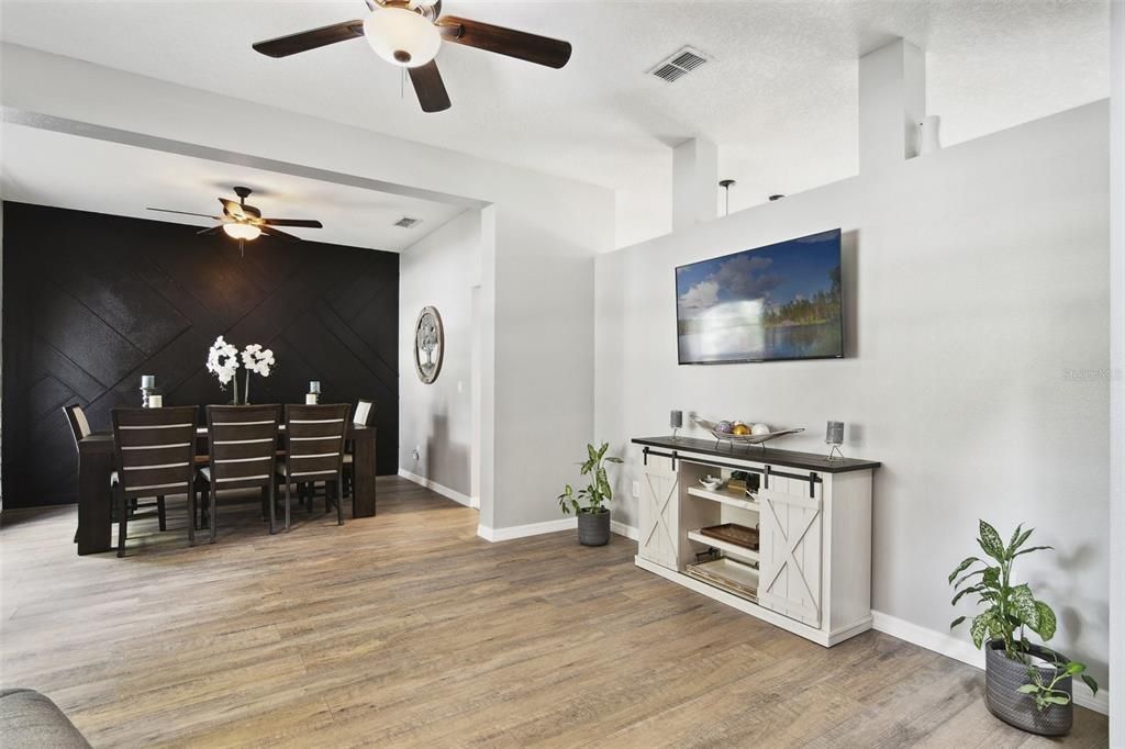 Living Room looking toward the Dining Room with stunning black accent wall.