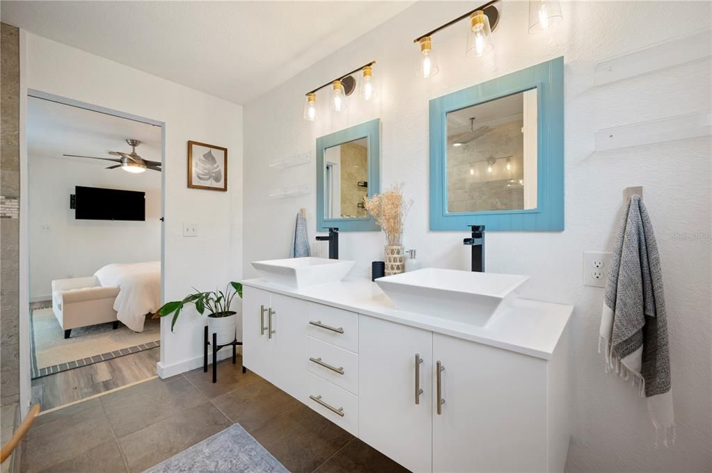 Upgraded bathroom with dual-sink floating vanity and walk-in shower