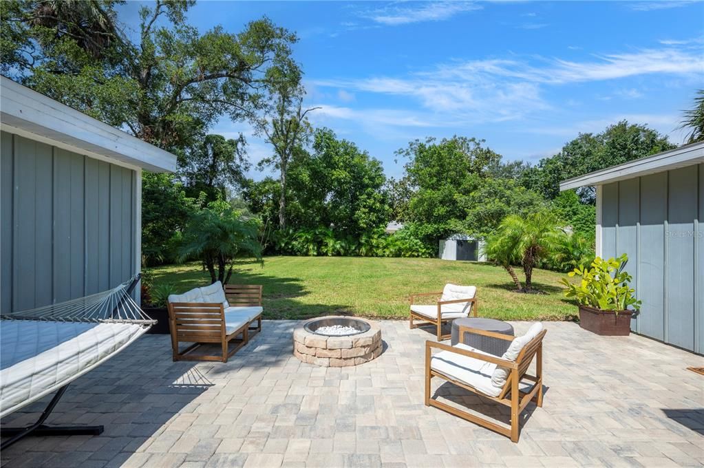 View of beautiful fenced in backyard with Areca palms for privacy