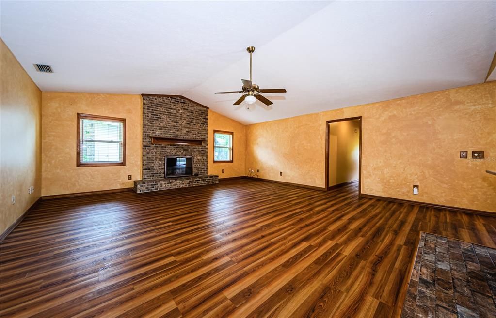 Great room with gas fireplace and vinyl flooring