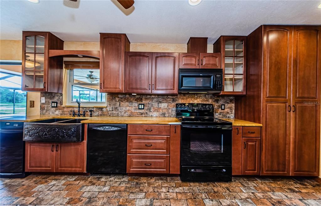 Lots of cabinets dual spice racks on either side of the stove