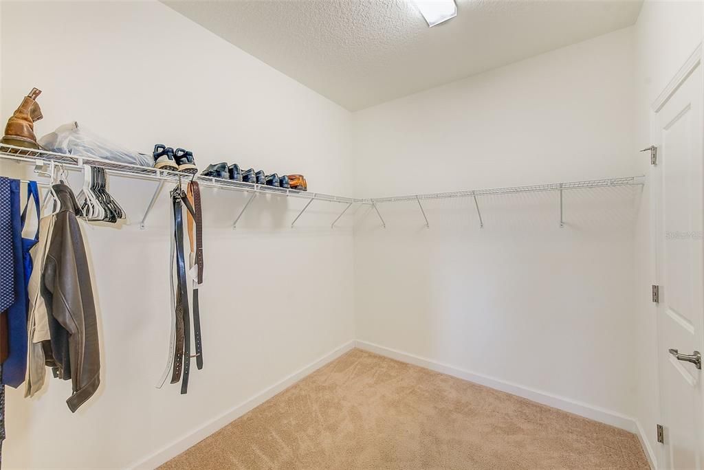 Primary bedroom walk in closet