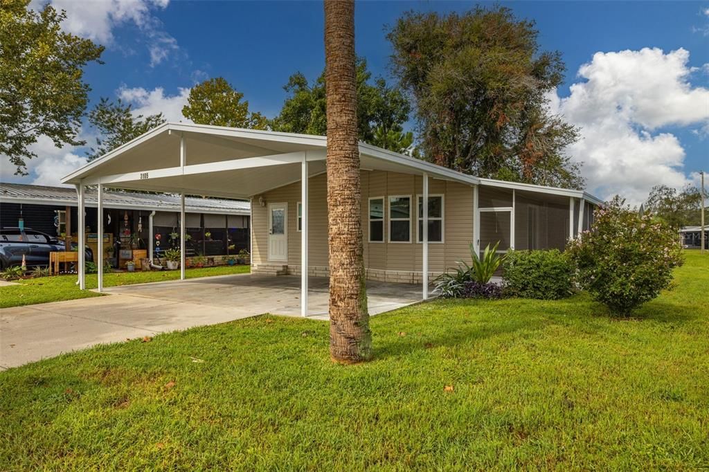 Features coveted, covered double parking pad/driveway with side screened-in porch.