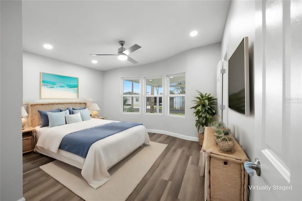 Large Primary Bedroom with new windows, recessed lighting, ceiling fan, luxury vinyl flooring and an AMAZING en-suite bathroom! (Virtually Staged)