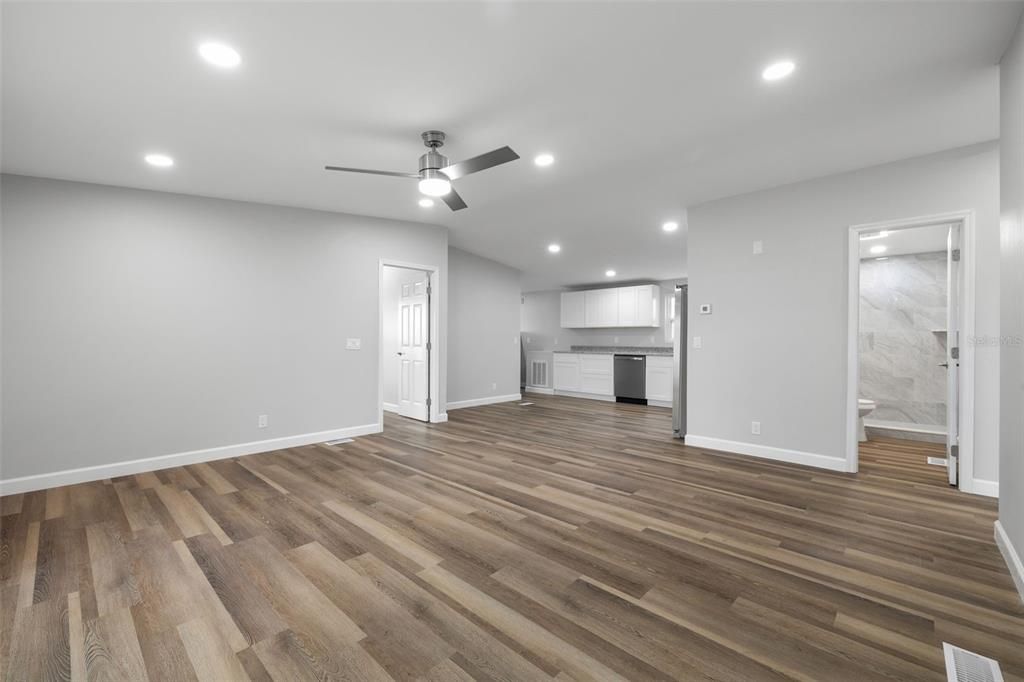 View from living room toward kitchen, and primary bedroom