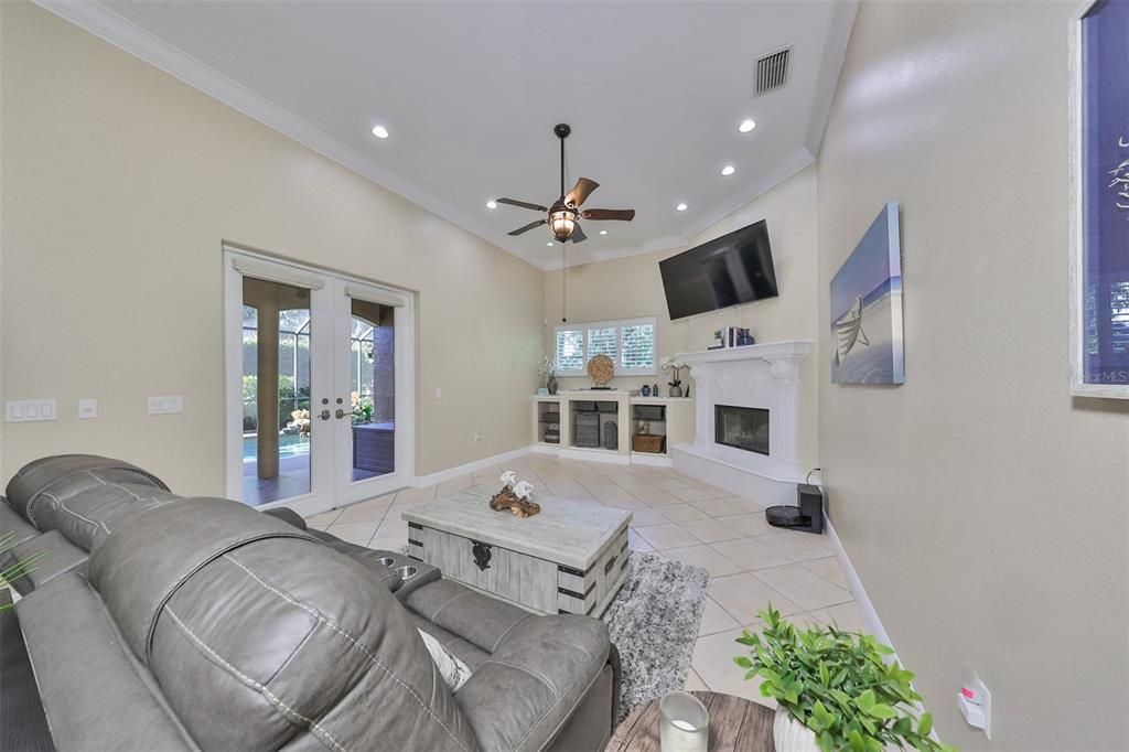 Family room with wood burning fireplace and double french doors lead you to your outdoor oasis area.