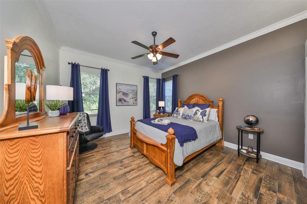 Large guest bedroom with porcelain tile flooring. Views of nature preserve.