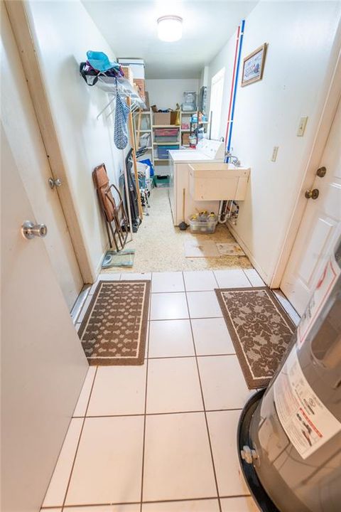 LAUNDRY ROOM W ACCESS TO BOTH THE GARAGE AND BACKYARD