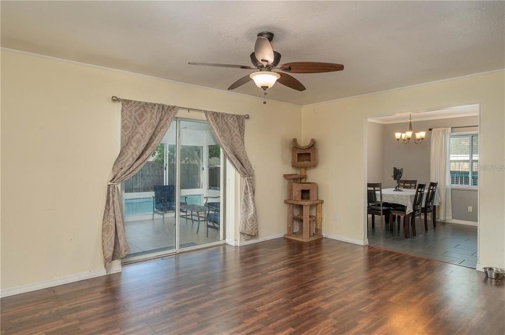 Interior photo showing dining room, and view to Florida room and pool.