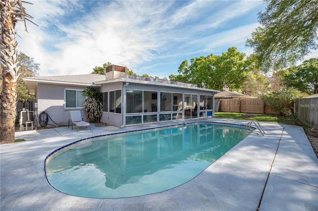 Backyard showing 15x30 pool, Florida room, and mature palm tree.