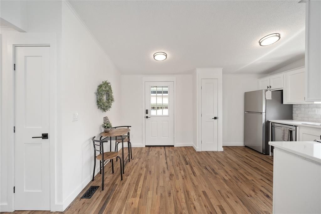 living room looking at front door with kitchen on the right side