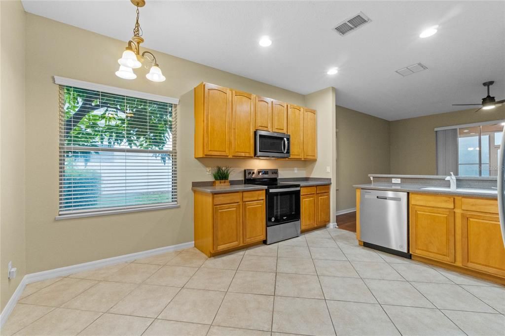 Beautifully maintained cabinets with pull out drawers, kitchen leading to laundry room