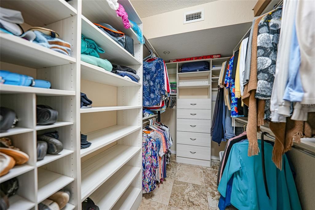 WALK-IN CLOSET WITH CUSTOM SHELVING, DRAWERS AND STORAGE