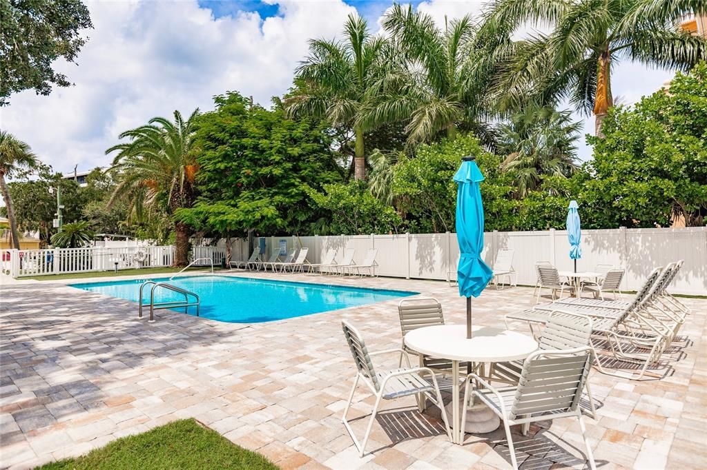 Multiple dining tables with umbrellas so you can hang out here all day!