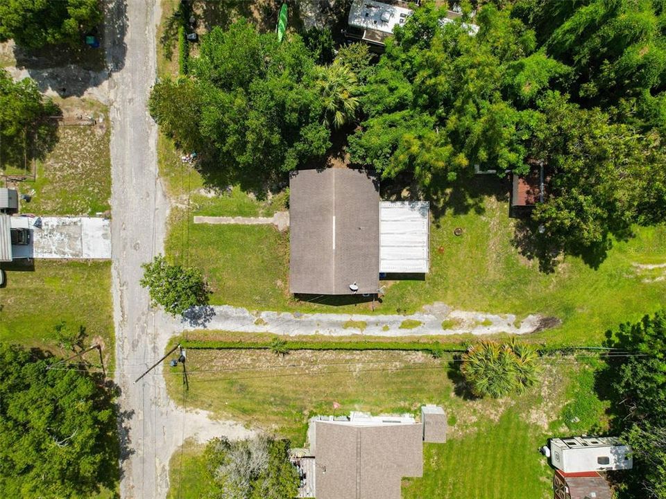 Shared driveway on the side leads to the garage and home behind.