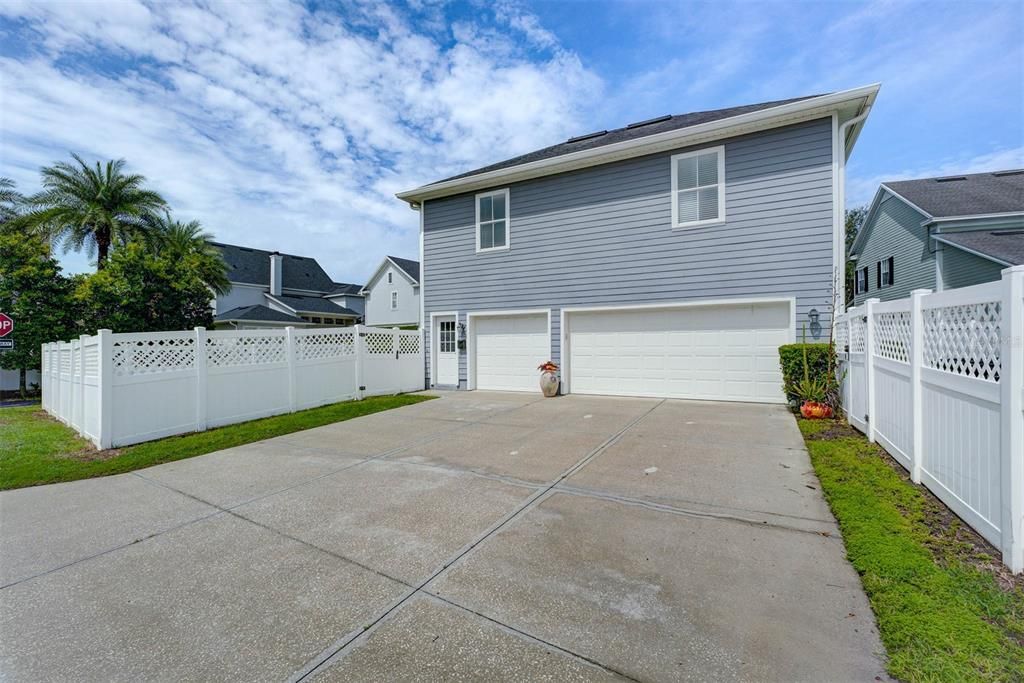 Long extended driveway leads to 3 car garage. There are 2 yards: one on each side of the driveway. Door on the left is for the garage apartment.