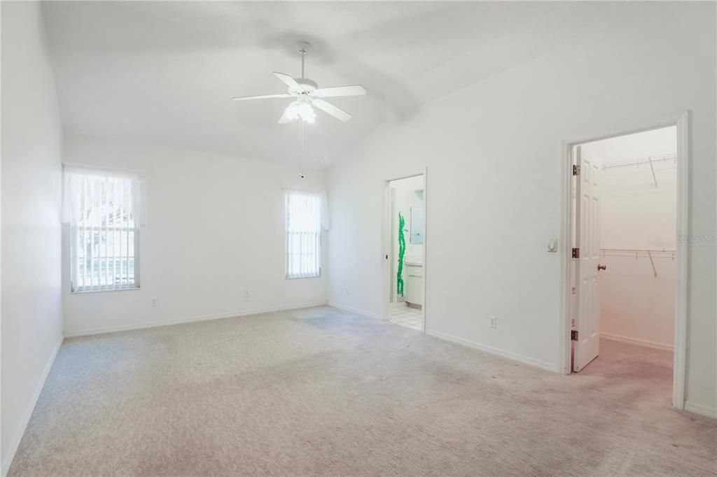 primary bedroom also has a vaulted ceiling