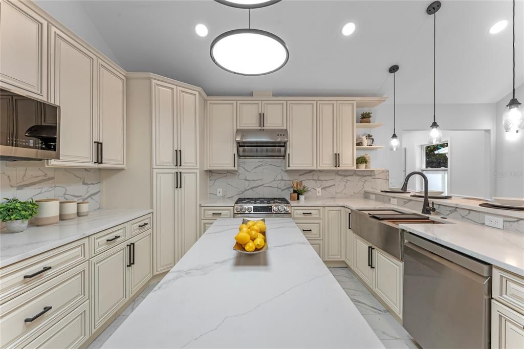 Gas 5 burner range with center grill top. Check out the oversized stainless apron sink with multiple prep areas!