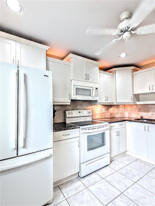 Staggered cabinet heights with the lighting above gives this kitchen a nice touch.