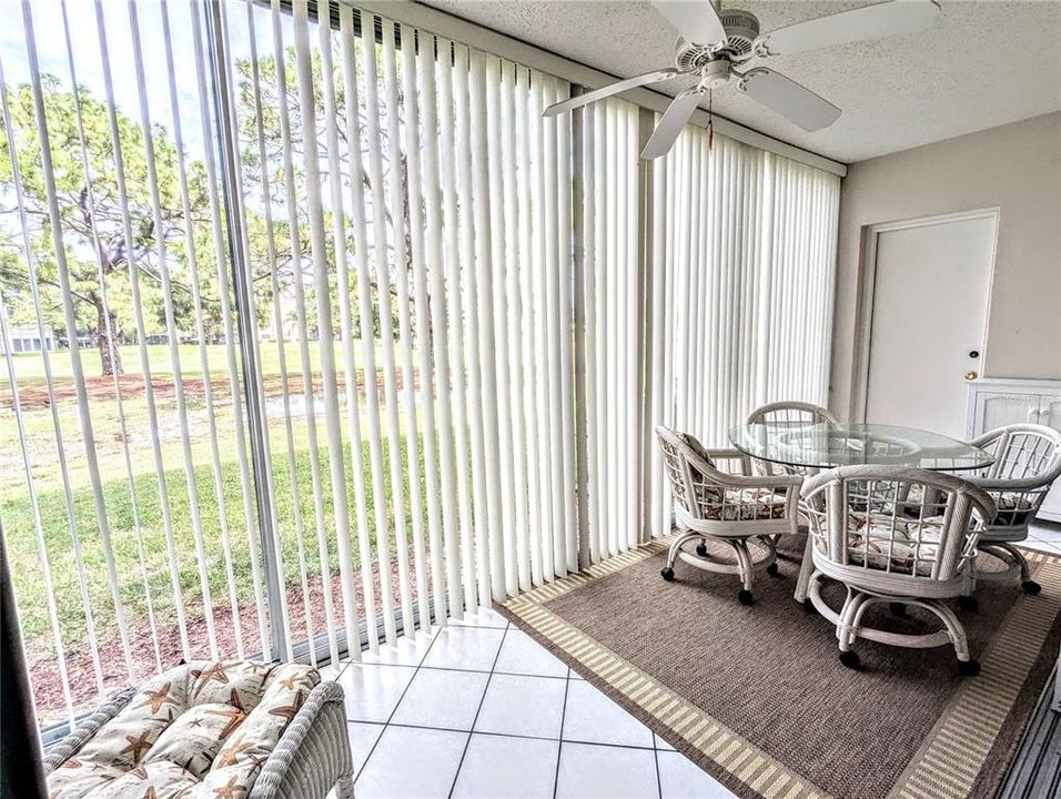 This beautifully enclosed lanai looks over the 13th hole.