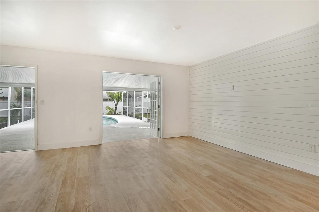 View from living room through 2 double doors leading to pool area.