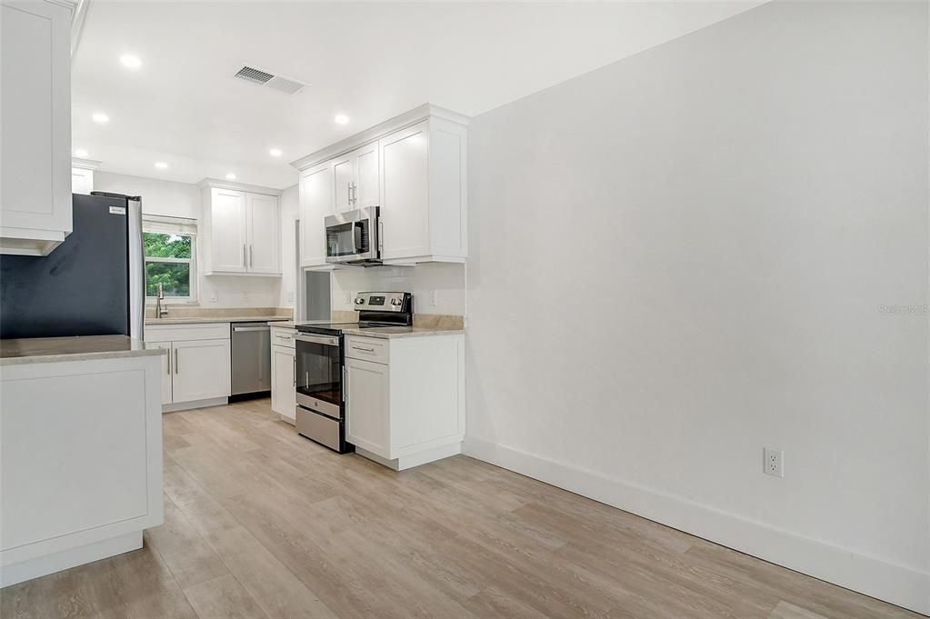 Totally remodeled kitchen with new cabinets, new counters and new stainless steel appliances.