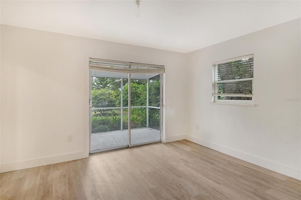 Master bedroom with sliding door leading to backyard and pool.