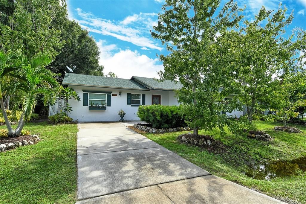 View from front door. Open concept living room leading to covered back patio and newly screened pool area.