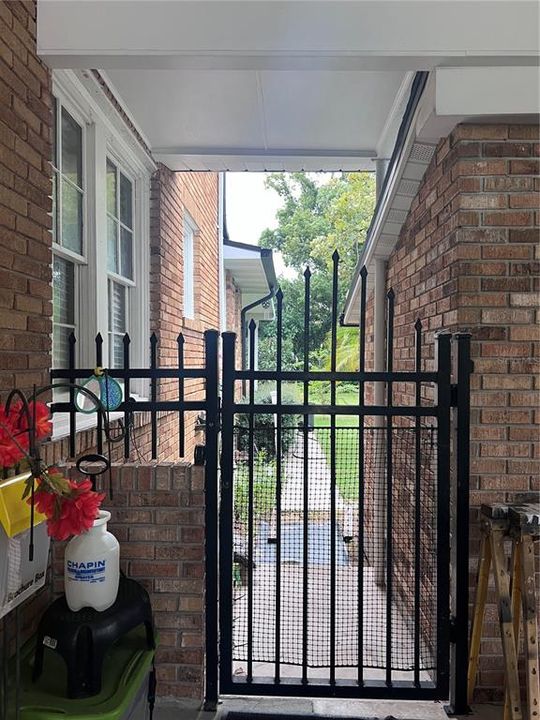 Side gate entrance to backyard from carport