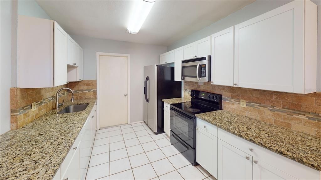 Kitchen offers tons of counter space and cabinets