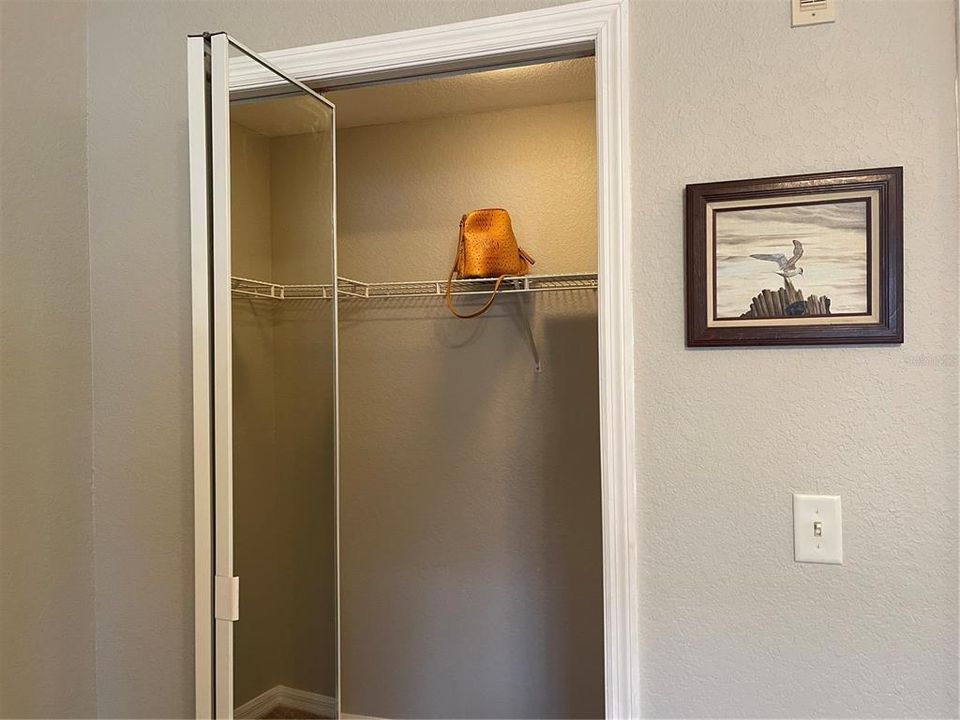 Walk in closet has mirrored bifold door