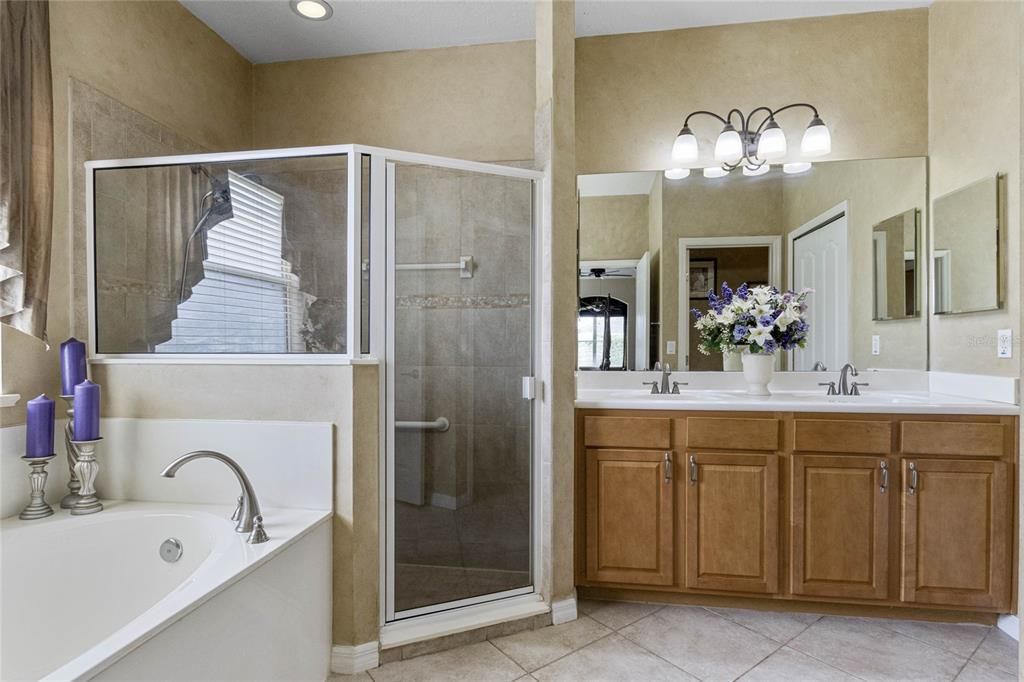 Master Bath features Comfort Height Vanity w/ Double Sinks, Linen Closet & Water Closet