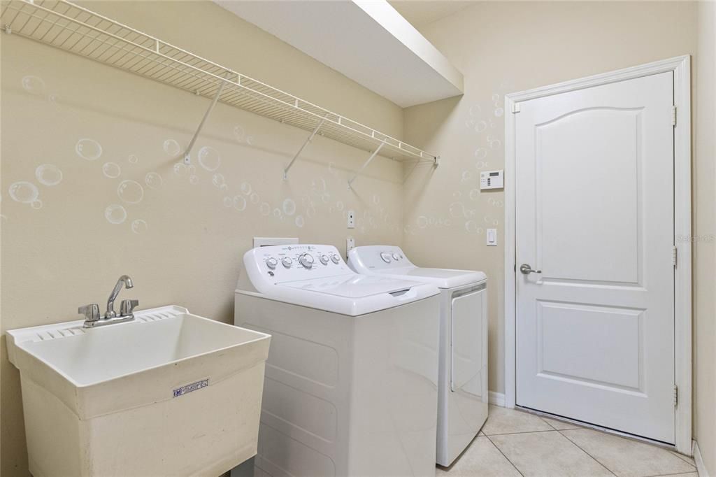 Laundry Room with Sink, Washer and Dryer, Shelves and a Luggage Shelf