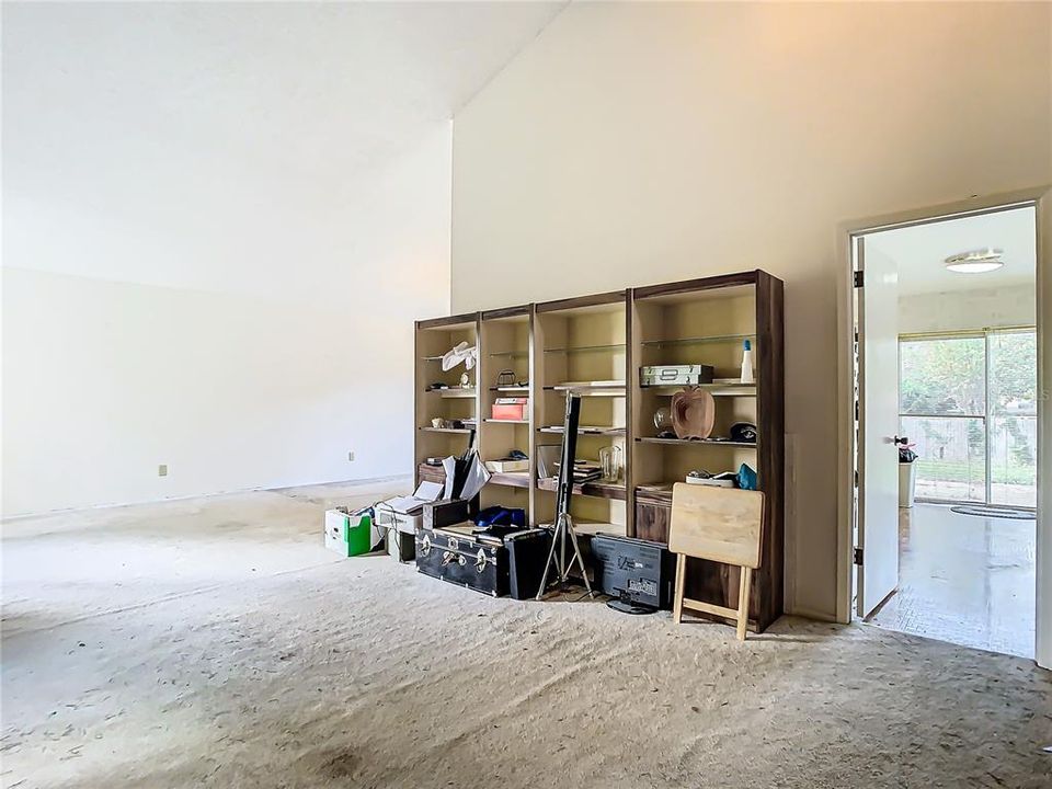 A view of the living room which takes you to the kitchen and family room or around the corner to the dining room.