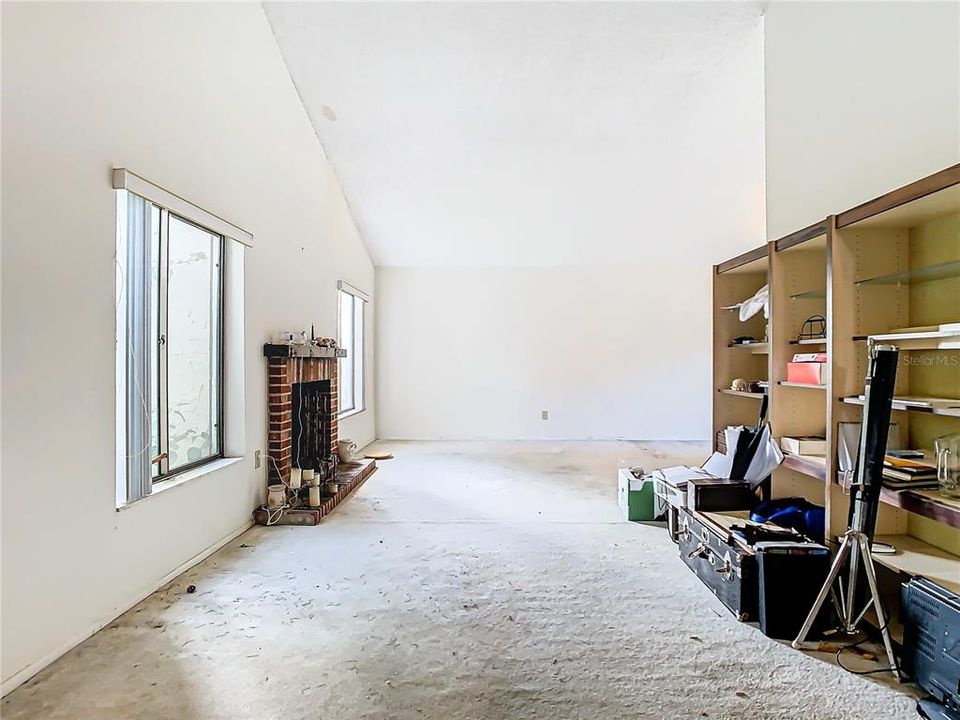 Another view of the living room with a vaulted ceiling.