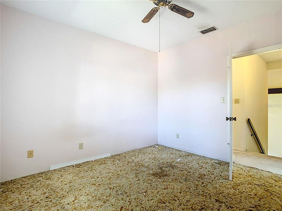 This guest bedroom is up the staircase from the living room.