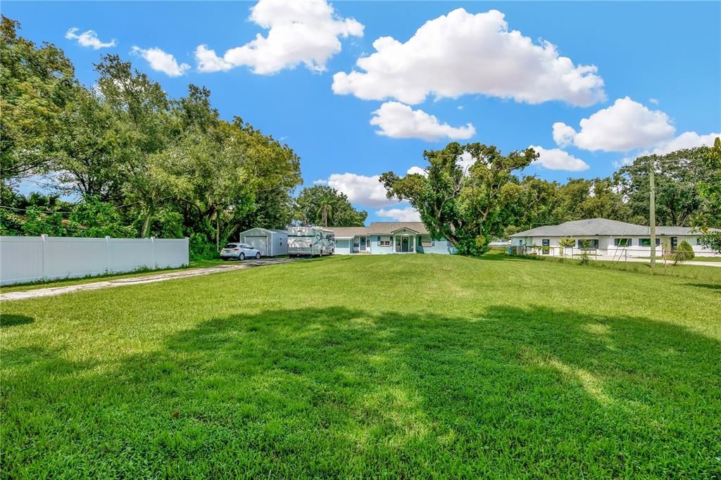 Large front yard, provides privacy. Fenced area to hide your toys, large shed stays.