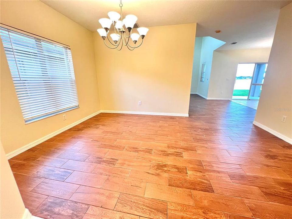 Enter into this beautiful dining room area with porcelain tile flooring.