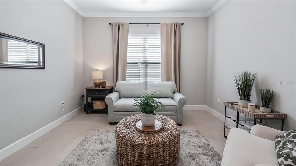 Office/Den/Study With Crown Molding and Tiled Flooring