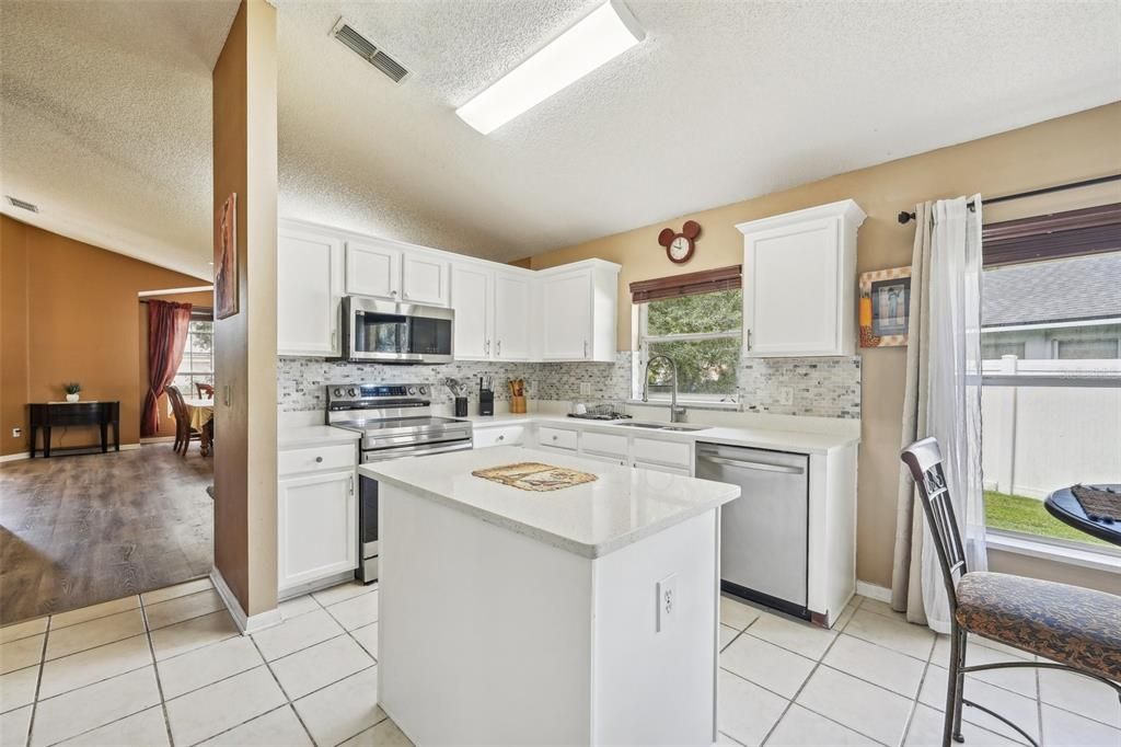 The UPDATED KITCHEN was crafted with the modern chef in mind and delivers a fresh color palette, QUARTZ COUNTERTOPS (that you will also find in both bathrooms!), NEW SAMSUNG STAINLESS STEEL APPLIANCES, a decorative backsplash and PREP ISLAND.