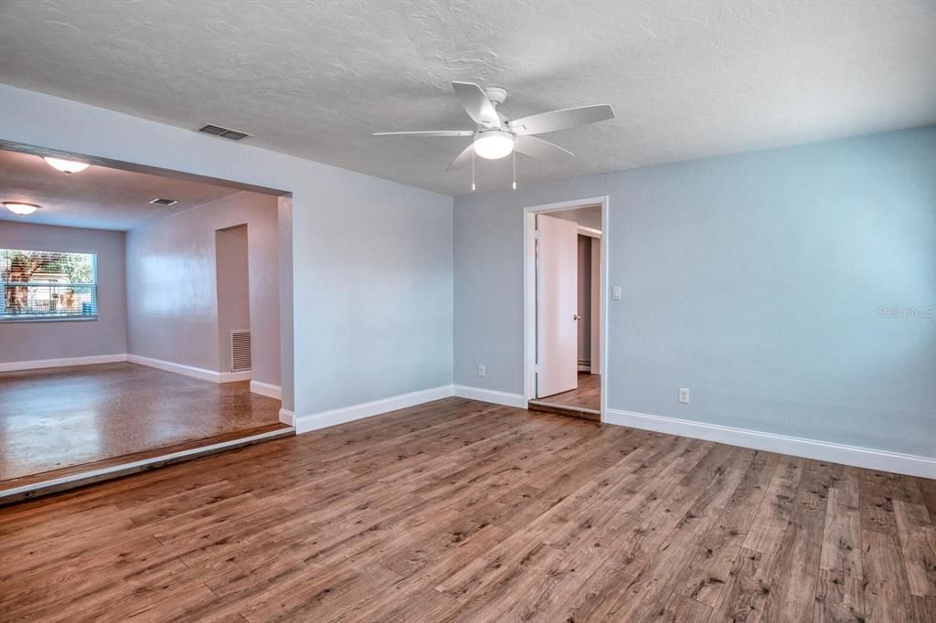 Family room with entry to hall and to primary bedroom visible