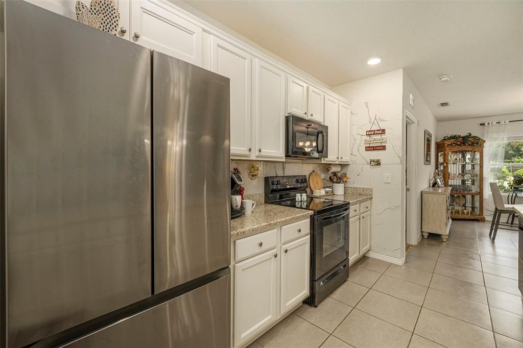 Plenty of cabinets, granite counters, breakfast bar, and two pantries