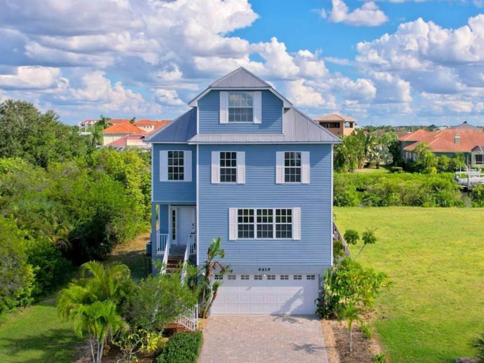 Extraordinary 4 story|5 bedroom|2.5 bath coastal lifestyle in Apollo Beach on canal with private dock and pool/spa.