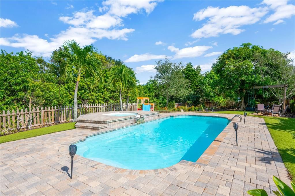 Heated chlorine pool and spillover spa in your backyard oasis.