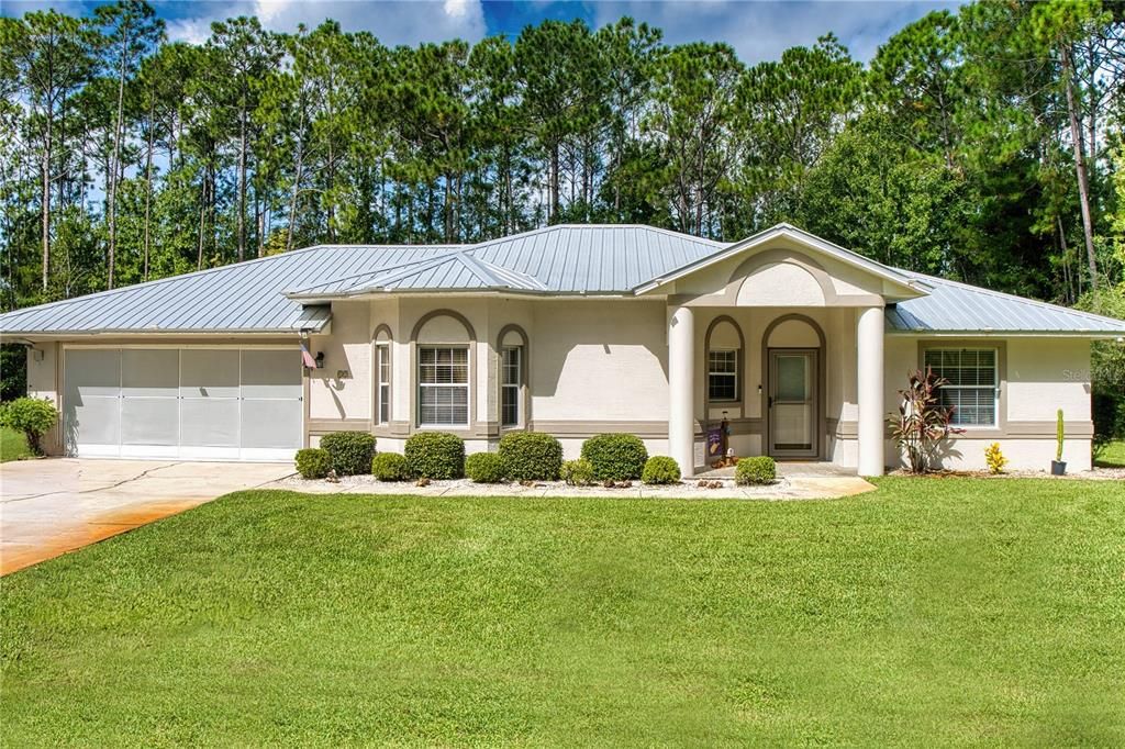 Front of Home with Metal RoofThis home boasts a stunning metal roof that not only enhances curb appeal but also offers superior durability and energy efficiency. Metal roofs last significantly longer than traditional roofing materials, providing homeowners with peace of mind and reduced maintenance costs.