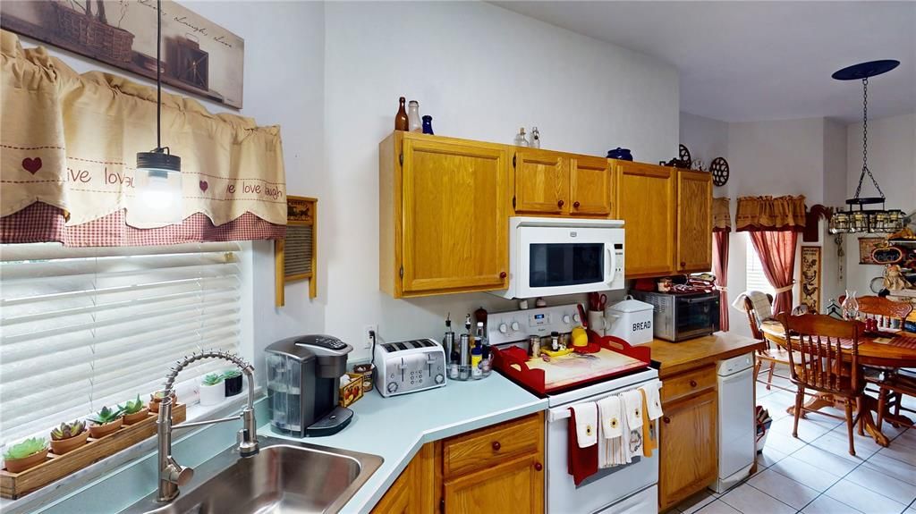 Kitchen with Real Wood Cabinets and Bay WindowEnjoy cooking in a kitchen that blends charm and practicality. The real wood cabinets offer durability and timeless style, while the large bay window allows natural light to flood the room, creating a warm, inviting space for meals and gatherings.