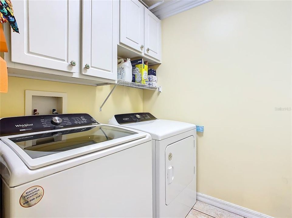 INSIDE LAUNDRY ROOM WITH CABINETS