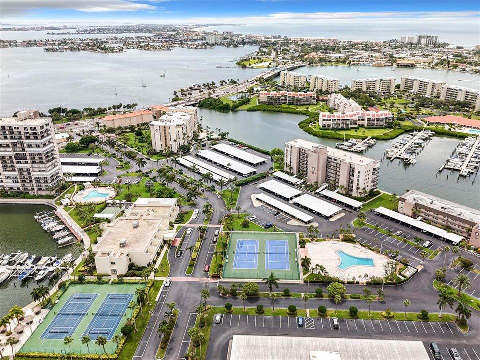 This is a great aerial view of the tennis & pickleball courts and the clubhouse plus two of the pools and the marina located inside of Bay Islands.